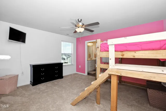 a room with a bed and a flat screen tv