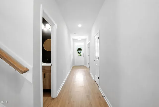 a view of hallway with wooden floor