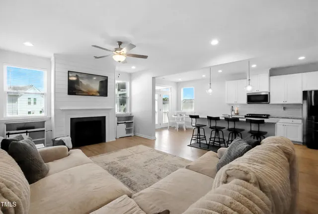 a living room with furniture a fireplace and a flat screen tv