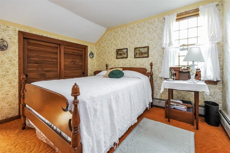 129 Cedar Hill Road East Dennis, MA 02660 - Photo 11 of 24 a bedroom with a bed and a table