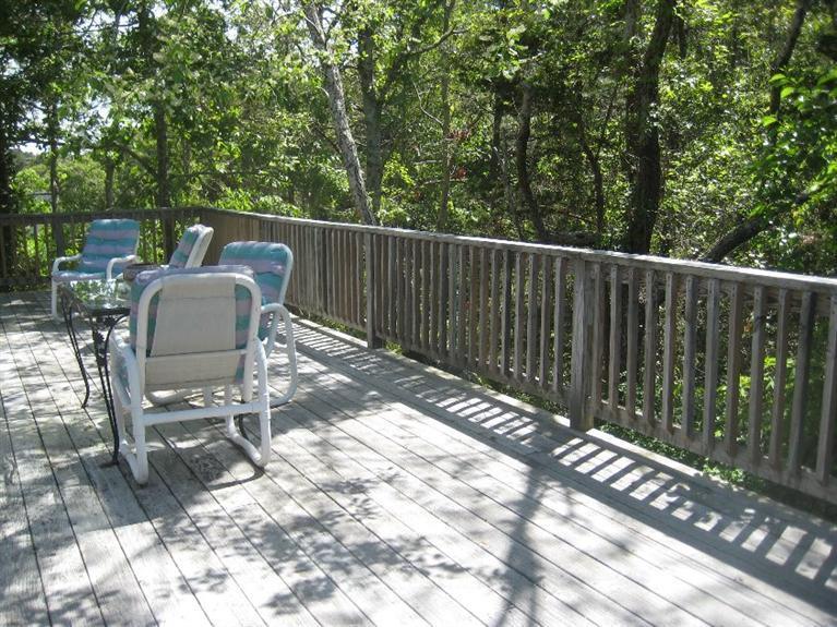 129 Cedar Hill Road East Dennis, MA 02660 - Photo 18 of 24 a view of a chair and table in the outdoor view