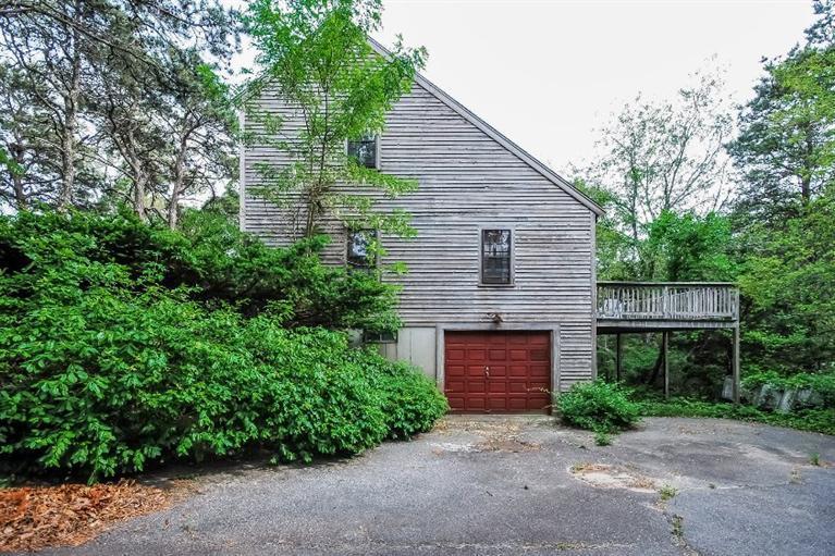 129 Cedar Hill Road East Dennis, MA 02660 - Photo 3 of 24 a front view of a house with garage