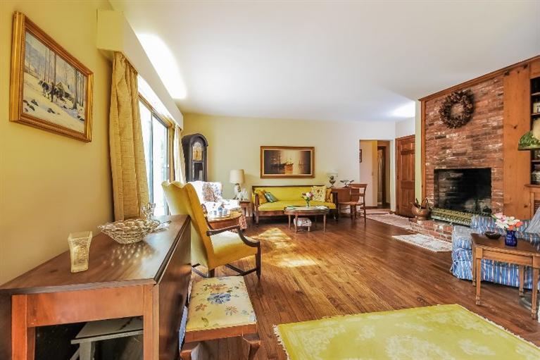 129 Cedar Hill Road East Dennis, MA 02660 - Photo 4 of 24 a living room with furniture a fireplace and a flat screen tv