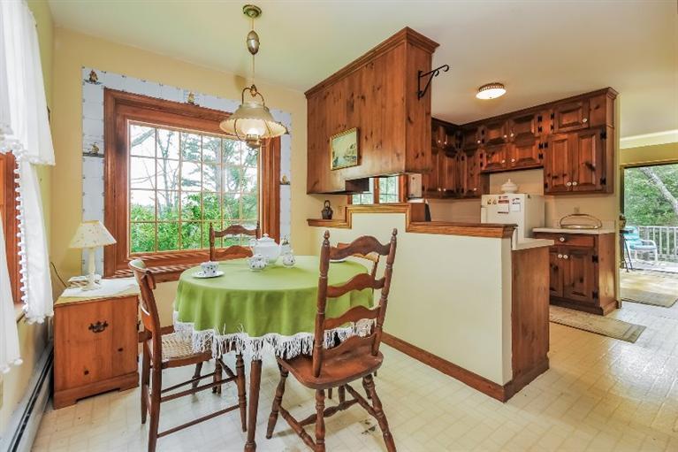 129 Cedar Hill Road East Dennis, MA 02660 - Photo 7 of 24 a dining room with furniture a chandelier and wooden floor