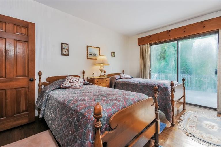 129 Cedar Hill Road East Dennis, MA 02660 - Photo 9 of 24 a bed room with a bed and a large window