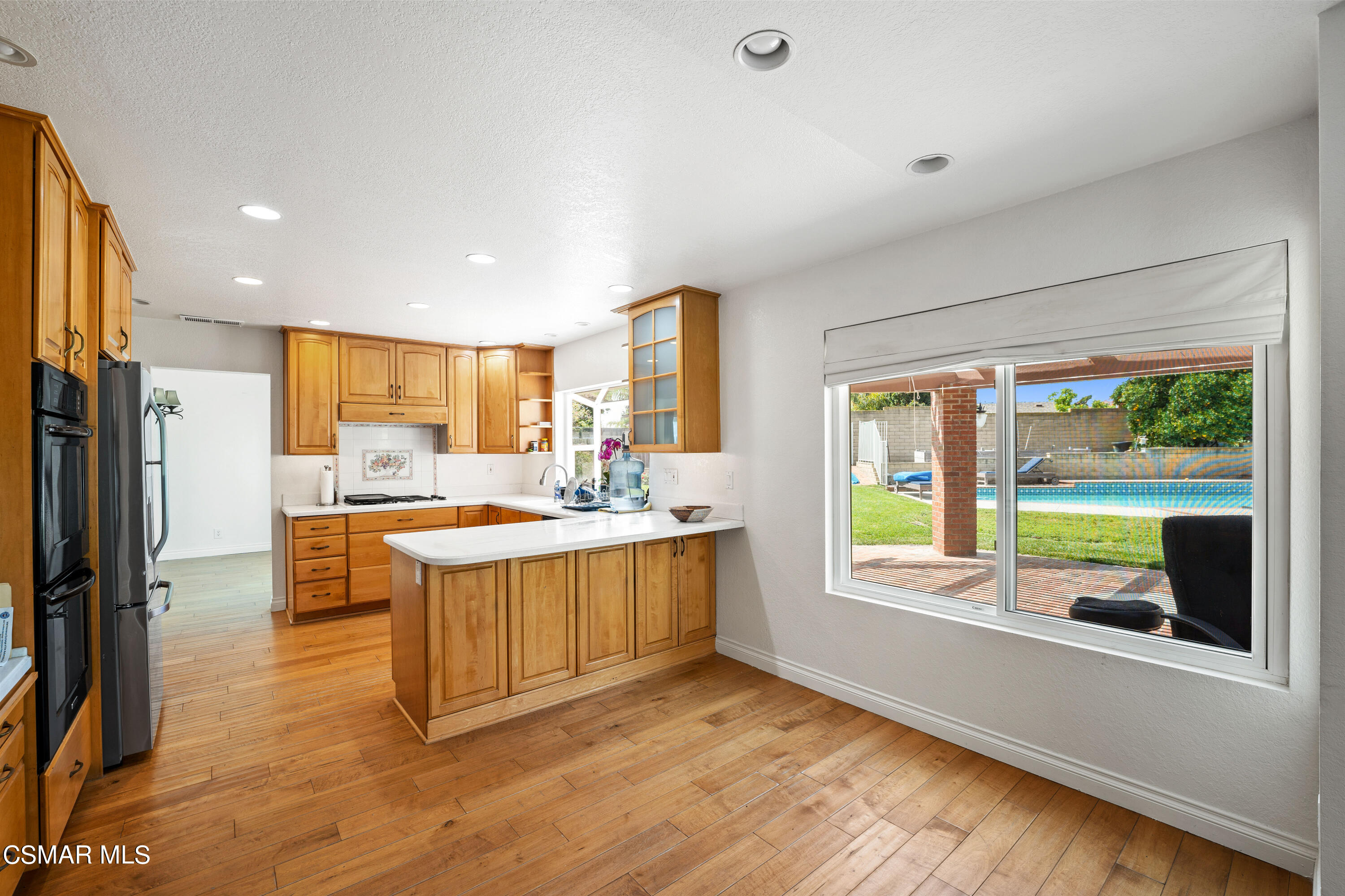 2835 Corte Caballos Camarillo, CA 93010 - Photo 12 of 35 a kitchen with stainless steel appliances granite countertop a stove a refrigerator a sink and a large window