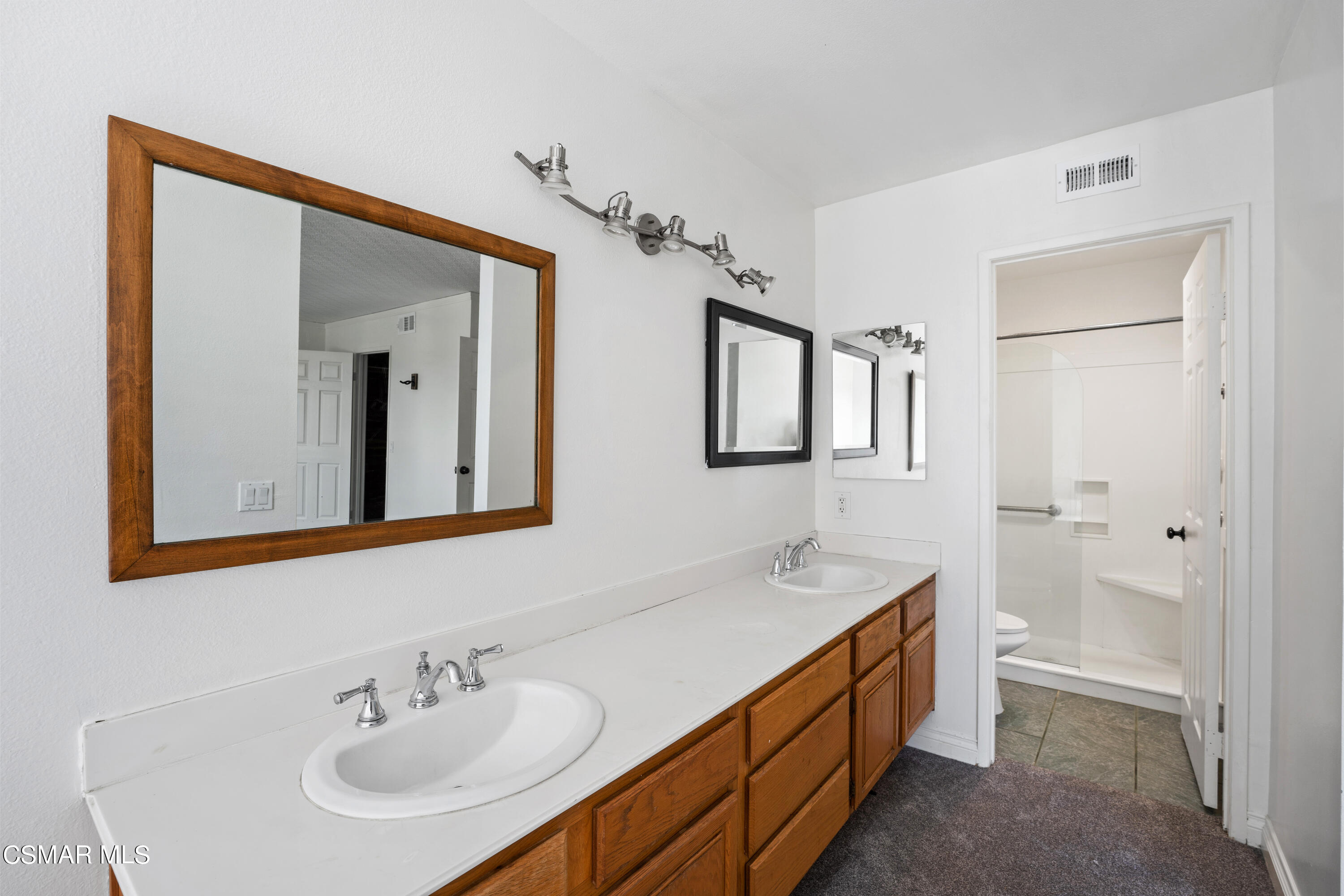 2835 Corte Caballos Camarillo, CA 93010 - Photo 21 of 35 a bathroom with double vanity sink and a mirror