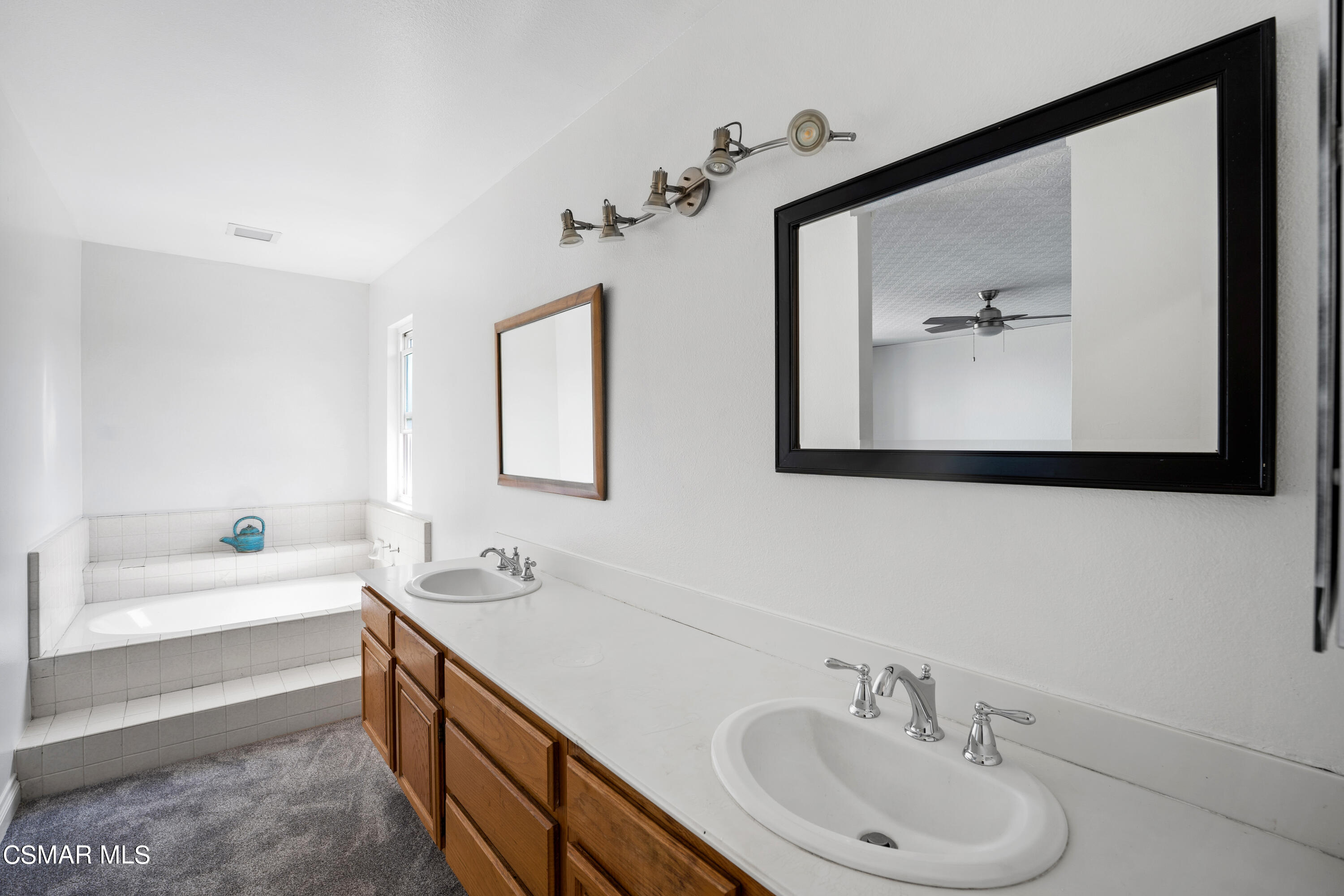 2835 Corte Caballos Camarillo, CA 93010 - Photo 22 of 35 a bathroom with a tub sink and mirror