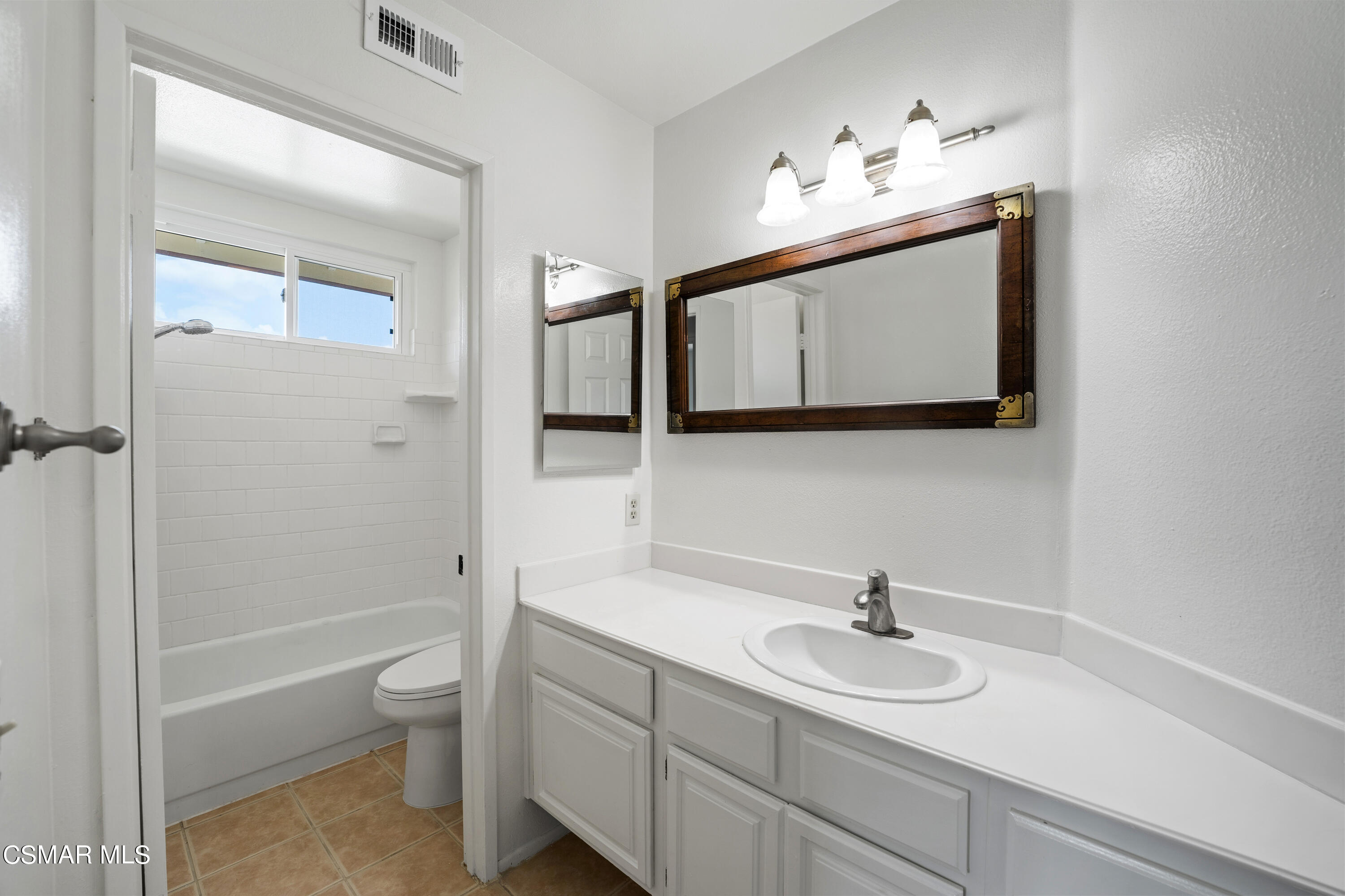 2835 Corte Caballos Camarillo, CA 93010 - Photo 25 of 35 a bathroom with a toilet a sink a mirror a shower a vanity and window