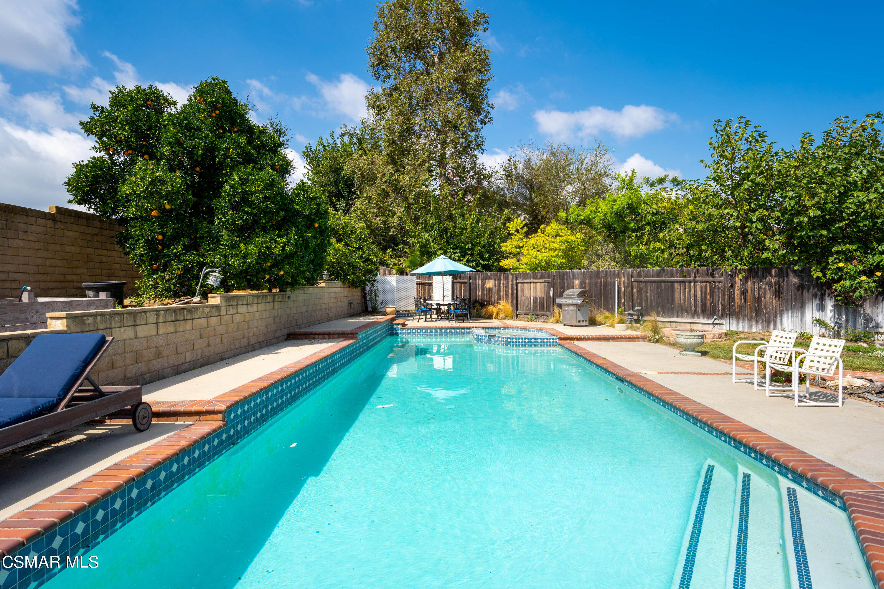 2835 Corte Caballos Camarillo, CA 93010 - Photo 32 of 35 a view of a swimming pool with a lounge chair
