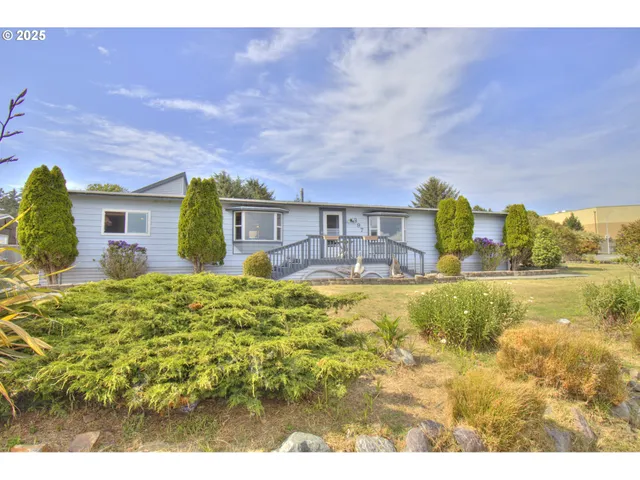a view of a balcony with wooden floor table and chairs