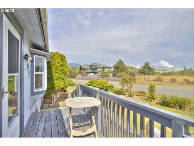 a living room with furniture a flat screen tv and lamp