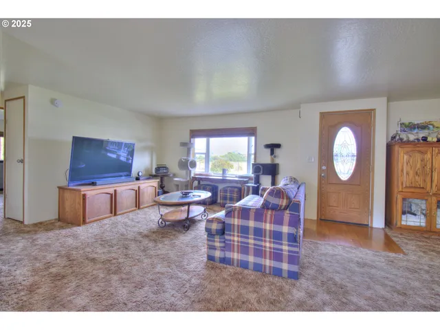 a living room with furniture a table and a large window