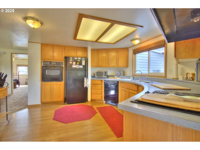 a kitchen with stainless steel appliances granite countertop a sink and cabinets