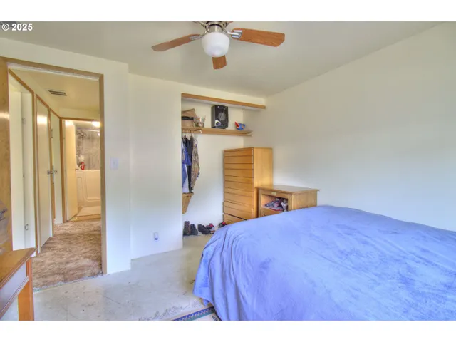 a bathroom with a granite countertop sink mirror vanity and toilet
