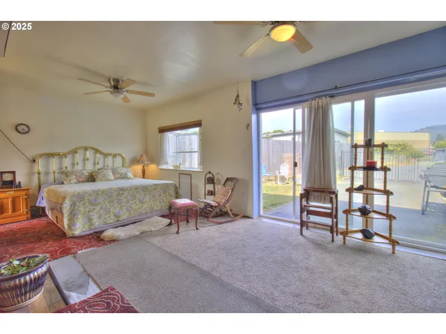 a bedroom with furniture and a large window