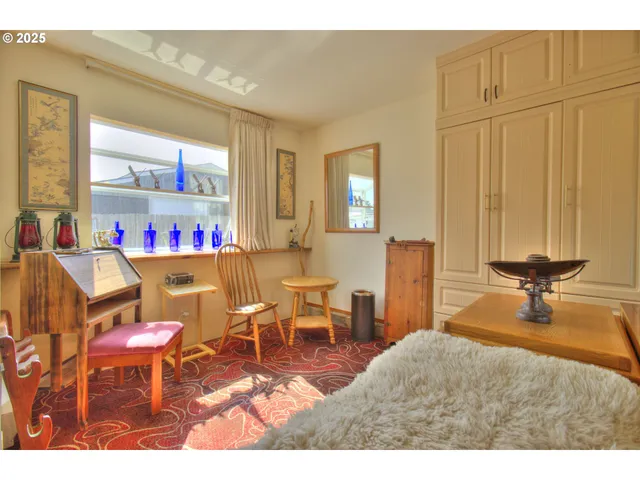 a living room with furniture a flat screen tv and a window