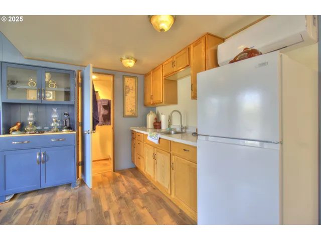 a kitchen with stainless steel appliances a refrigerator and a wooden cabinets