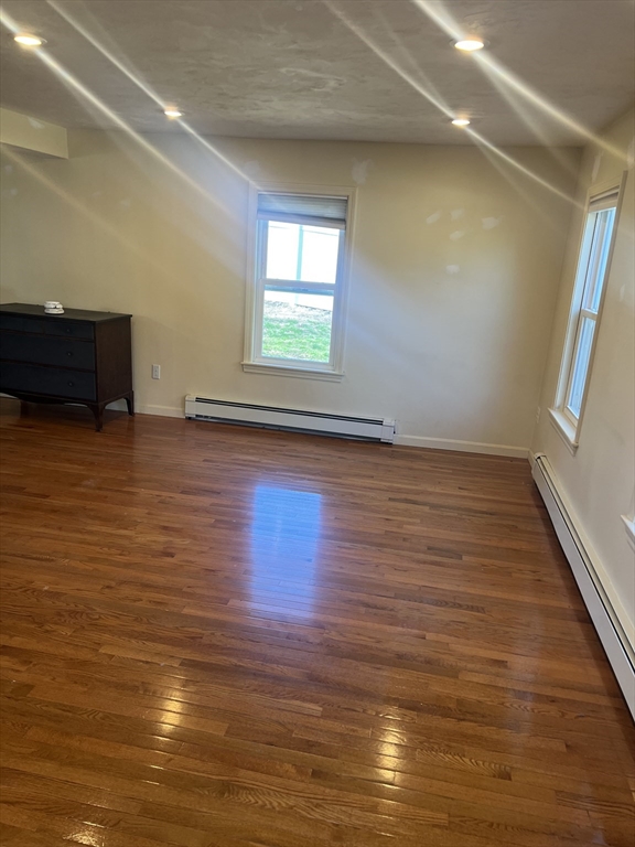 133 Pond Street Sharon, MA 02067 - Photo 11 of 17 a view of empty room with wooden floor and fan