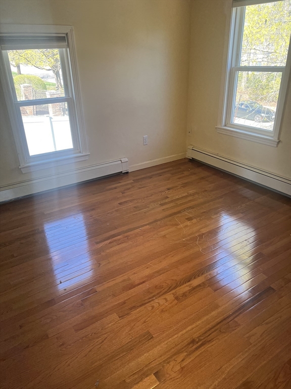 133 Pond Street Sharon, MA 02067 - Photo 6 of 17 an empty room with wooden floor and windows