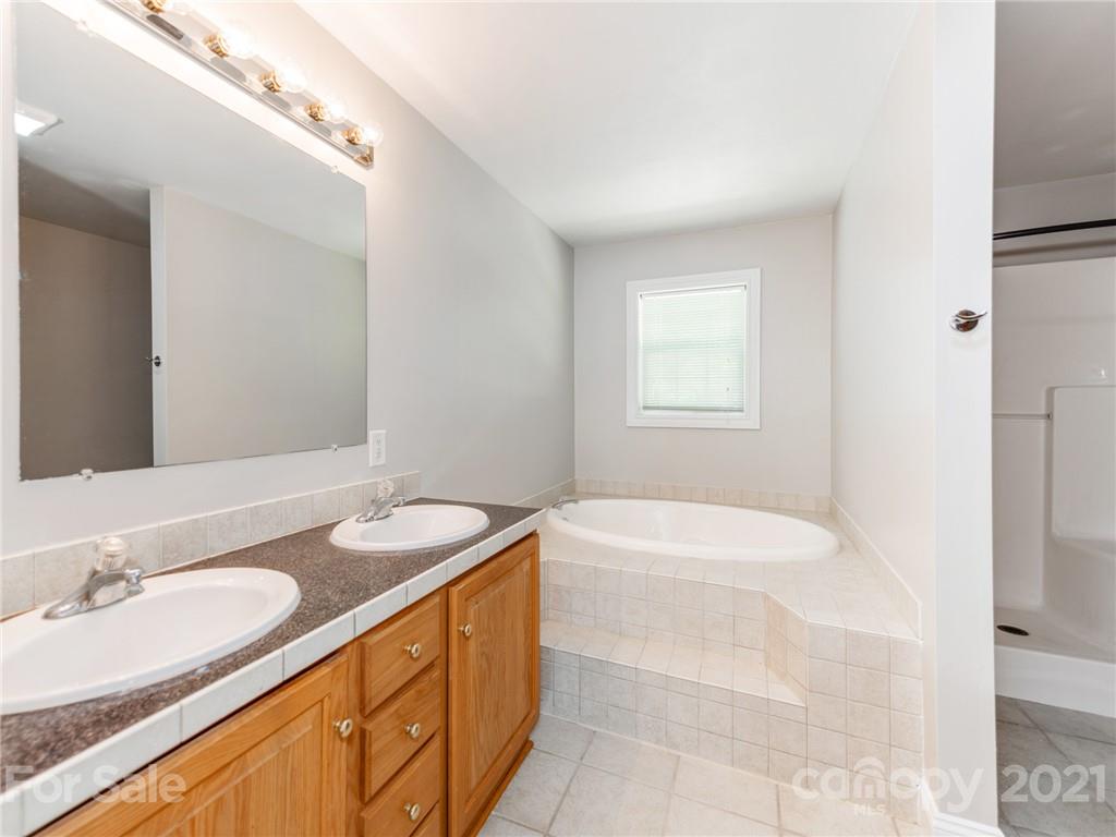 2295 Armenia Road Chester, SC 29706 - Photo 21 of 46 a bathroom with a granite countertop sink and a bathtub