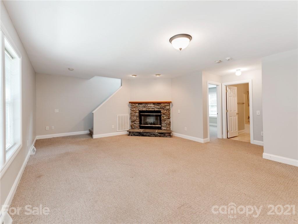 2295 Armenia Road Chester, SC 29706 - Photo 9 of 46 an empty room with fireplace and windows