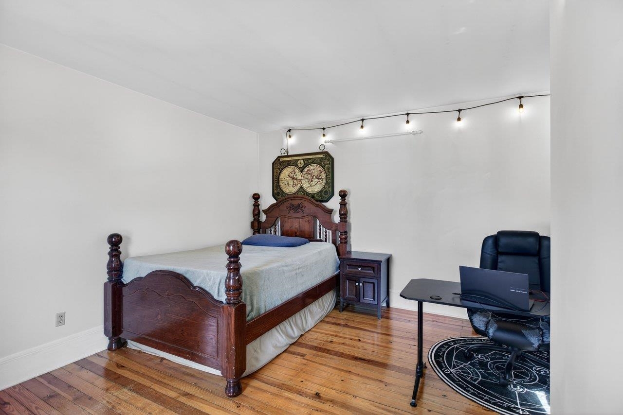 420 West Spring Street Woodstock, VA 22664 - Photo 35 of 67 a bedroom with a bed and wooden floor