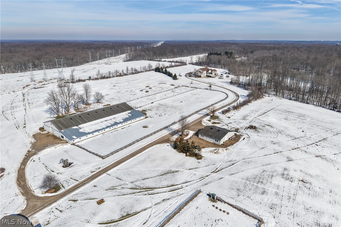 9455 Robinson Road Chardon, OH 44024 - Photo 8 of 33 Snowy aerial view featuring a wooded view