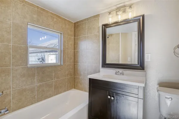 a bathroom with a bathtub a shower a sink and mirror