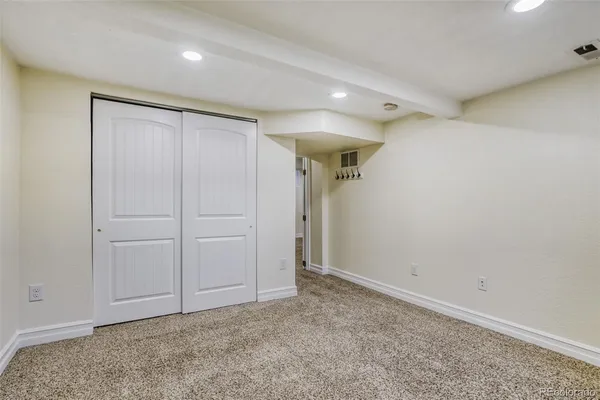 an empty room with closet area