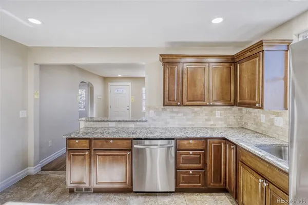 a kitchen with stainless steel appliances granite countertop a sink and a granite counter tops