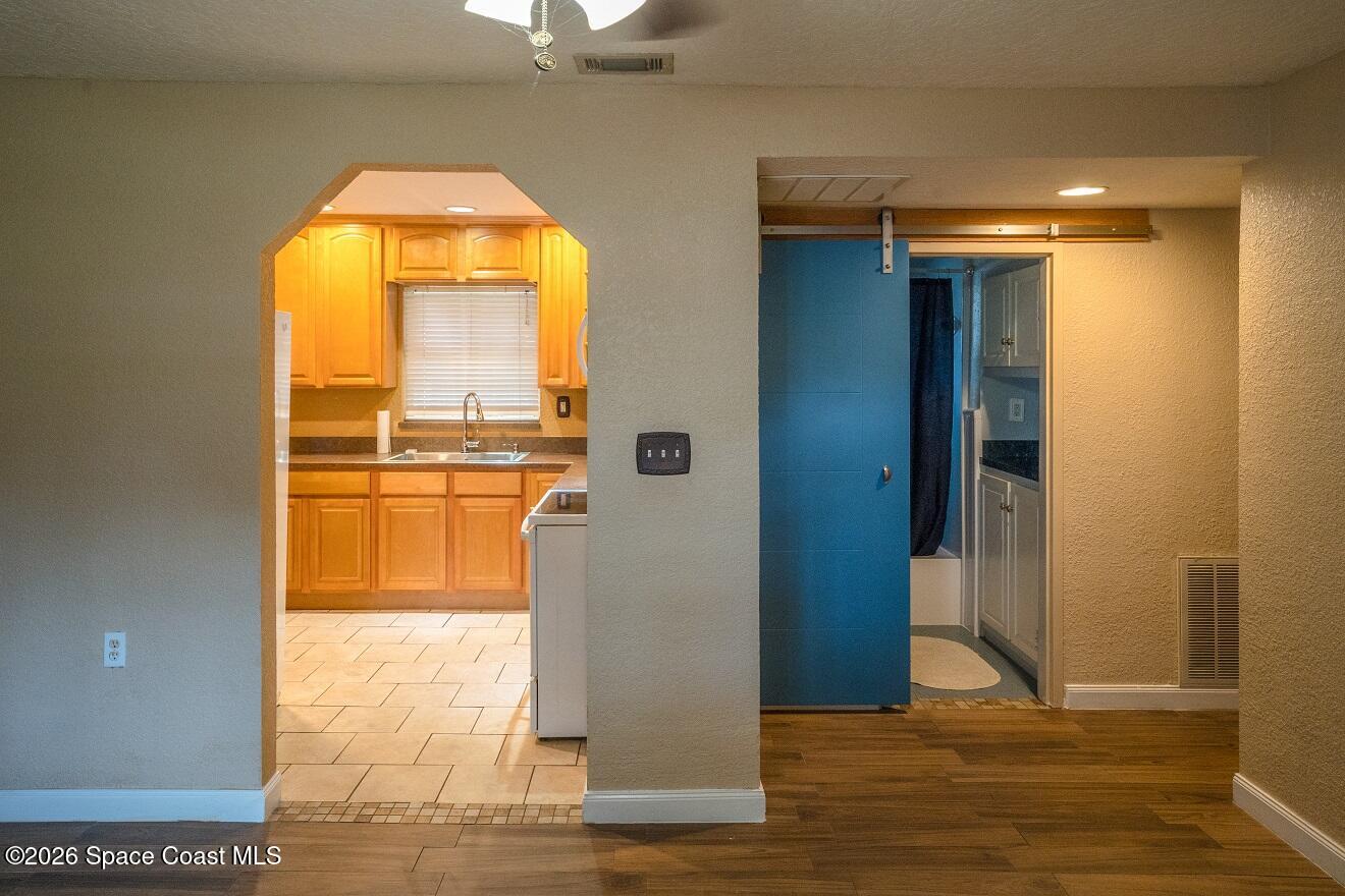 1112 Pinedale Road Rockledge, FL 32955 - Photo 5 of 15 a view of an empty room with wooden floor and a window