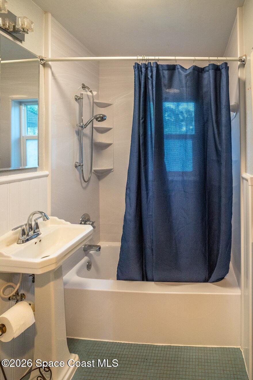 1112 Pinedale Road Rockledge, FL 32955 - Photo 6 of 15 a bathroom with a sink and a mirror