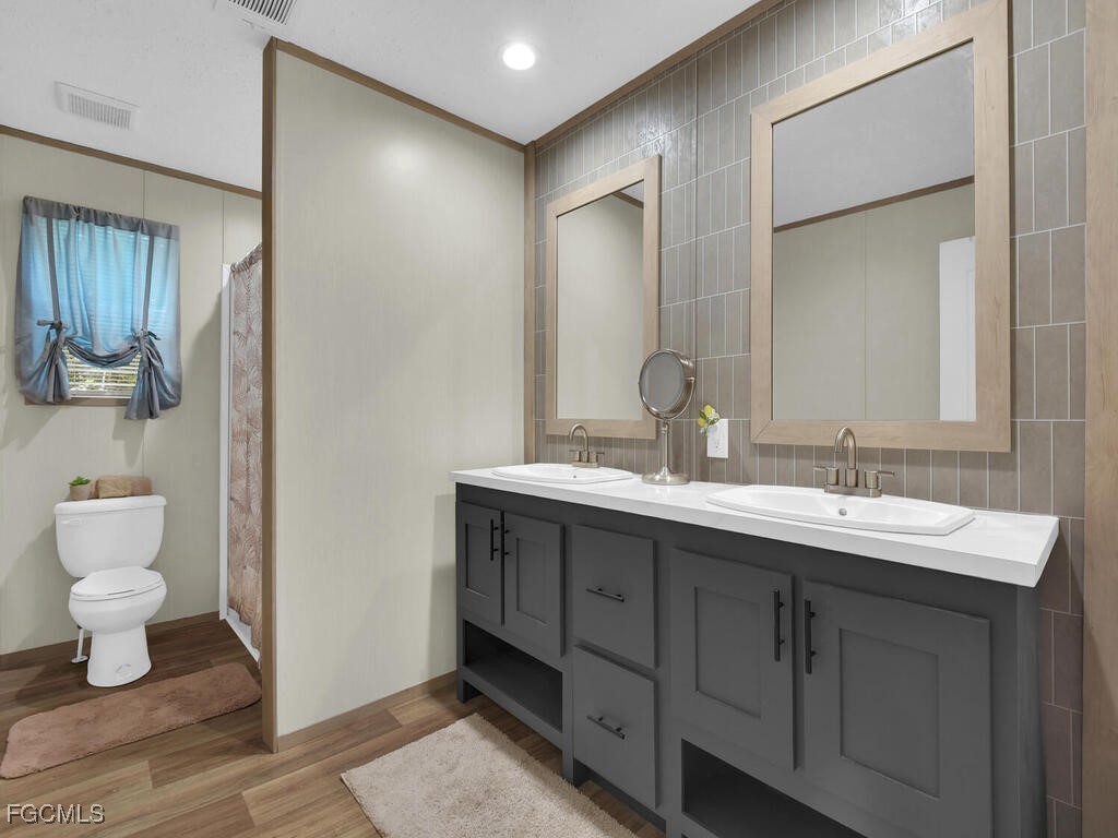 1079 Summerall Road LaBelle, FL 33935 - Photo 12 of 26 a bathroom with a sink and a mirror