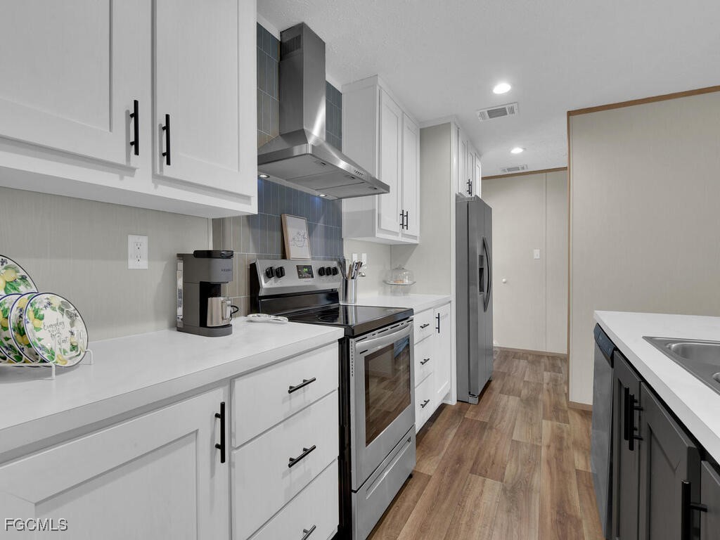 1079 Summerall Road LaBelle, FL 33935 - Photo 8 of 26 a kitchen with stainless steel appliances granite countertop a sink a stove a refrigerator and cabinets