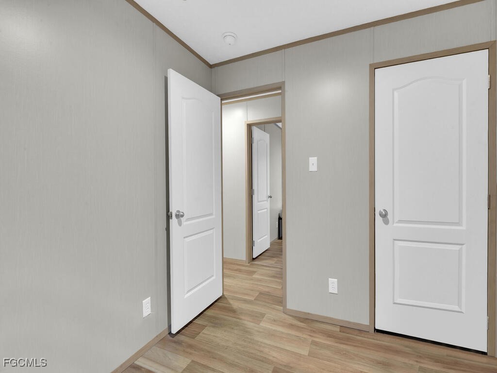 1079 Summerall Road LaBelle, FL 33935 - Photo 10 of 26 an empty room with wooden floor and closet