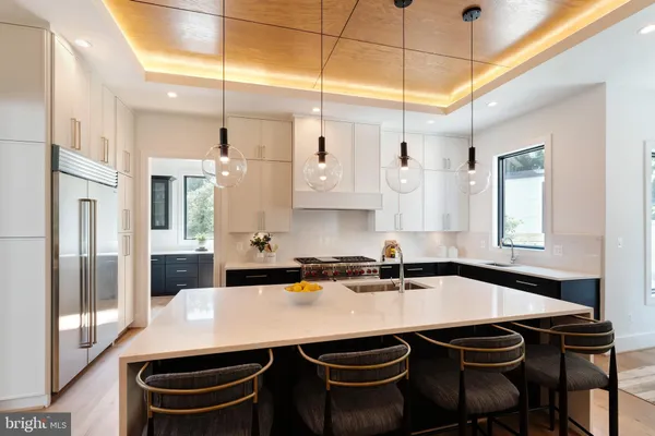 a kitchen with a table chairs sink and cabinets