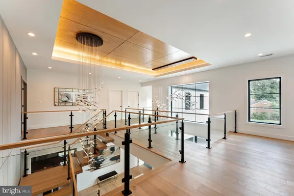 a spacious bedroom with a bed a table and large window