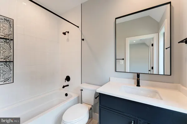 a bathroom with a sink toilet a mirror and shower