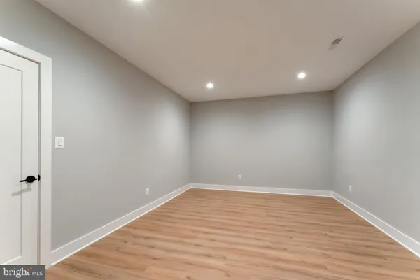 a view of a dining room with furniture large windows and wooden floor