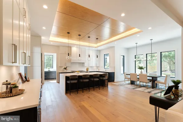 a large living room with stainless steel appliances granite countertop a stove and large window