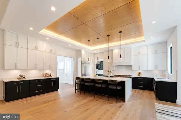 a kitchen with stainless steel appliances a sink a stove a refrigerator and cabinets