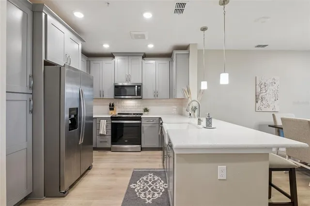a kitchen with stainless steel appliances white cabinets and a stove