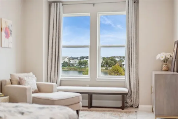 a bedroom with a bed and a large window