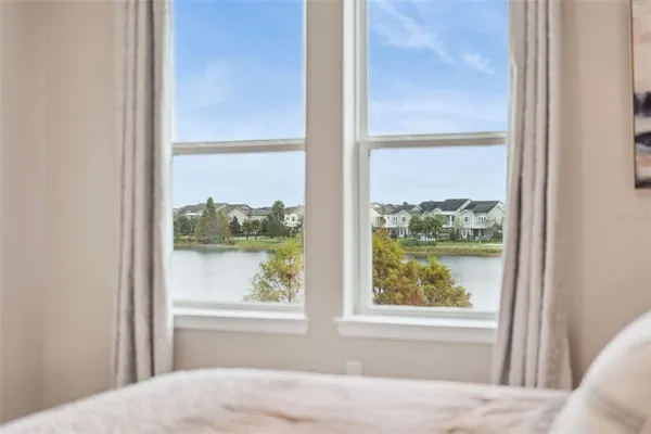 a view of a green field with building in the background