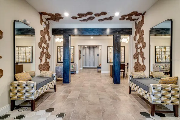 a living room with furniture a flat screen tv and kitchen view