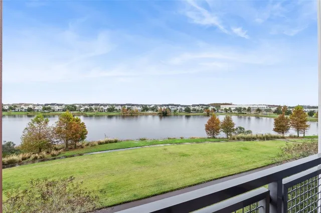 a living room with furniture a flat screen tv and kitchen view