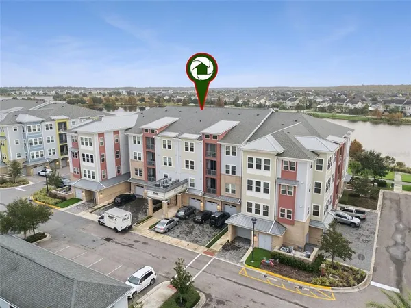 a open kitchen with stainless steel appliances kitchen island granite countertop a table chairs and a refrigerator