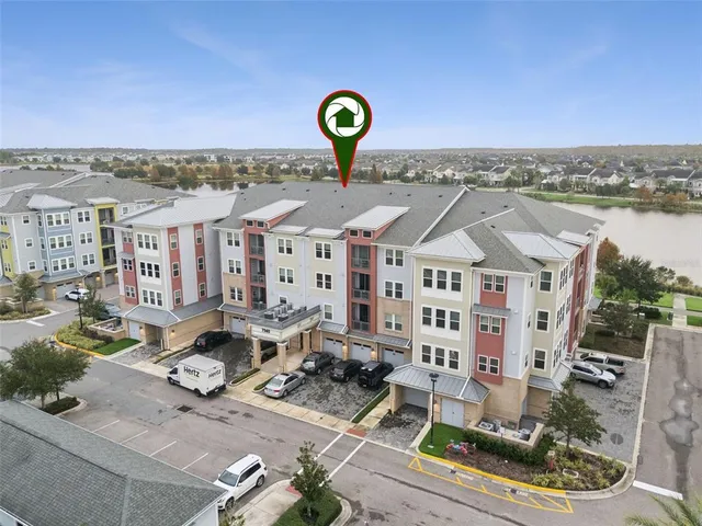 a view of a green field with building in the background