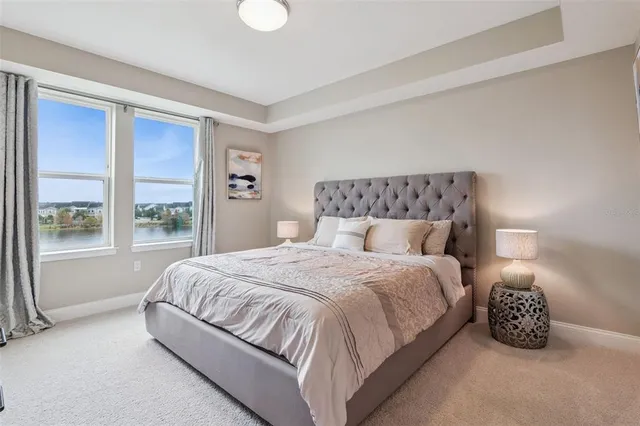 a bedroom with a bed and a large window